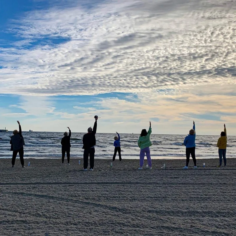 A group exercising on Sopot beach.