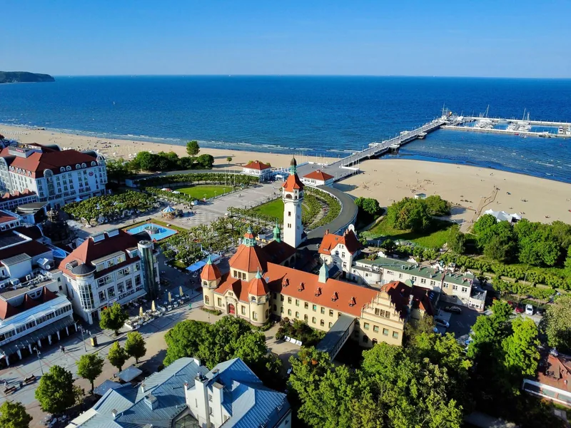 A drone view of historic buildings, the pier and the beach in Sopot.