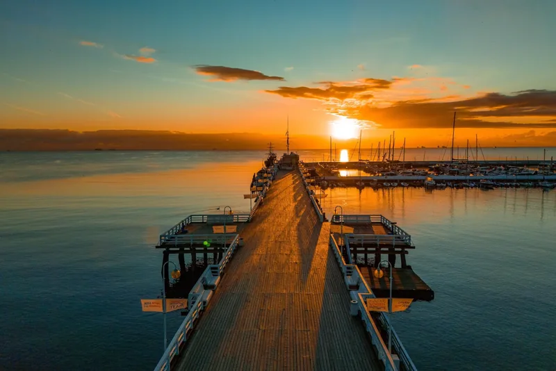 Sunrise over Sopot pier and the calm sea.