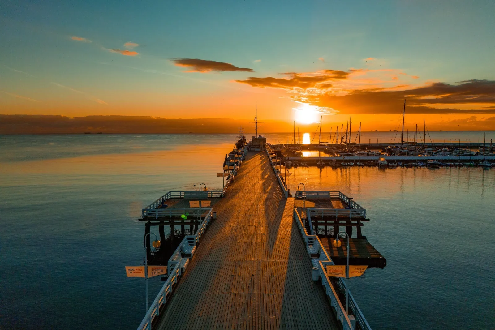Sunrise over Sopot pier and the calm sea.