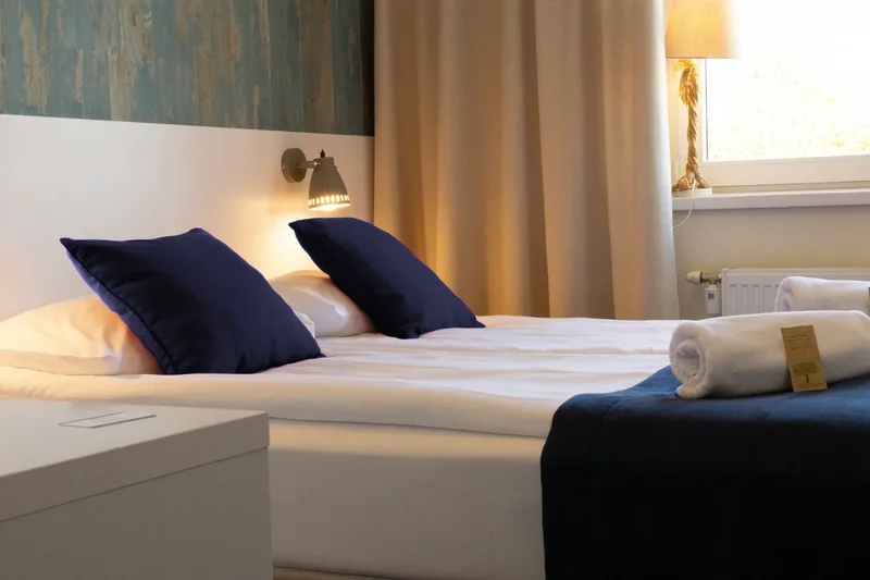Bed in a bright Deluxe room at SeaSide Sopot.